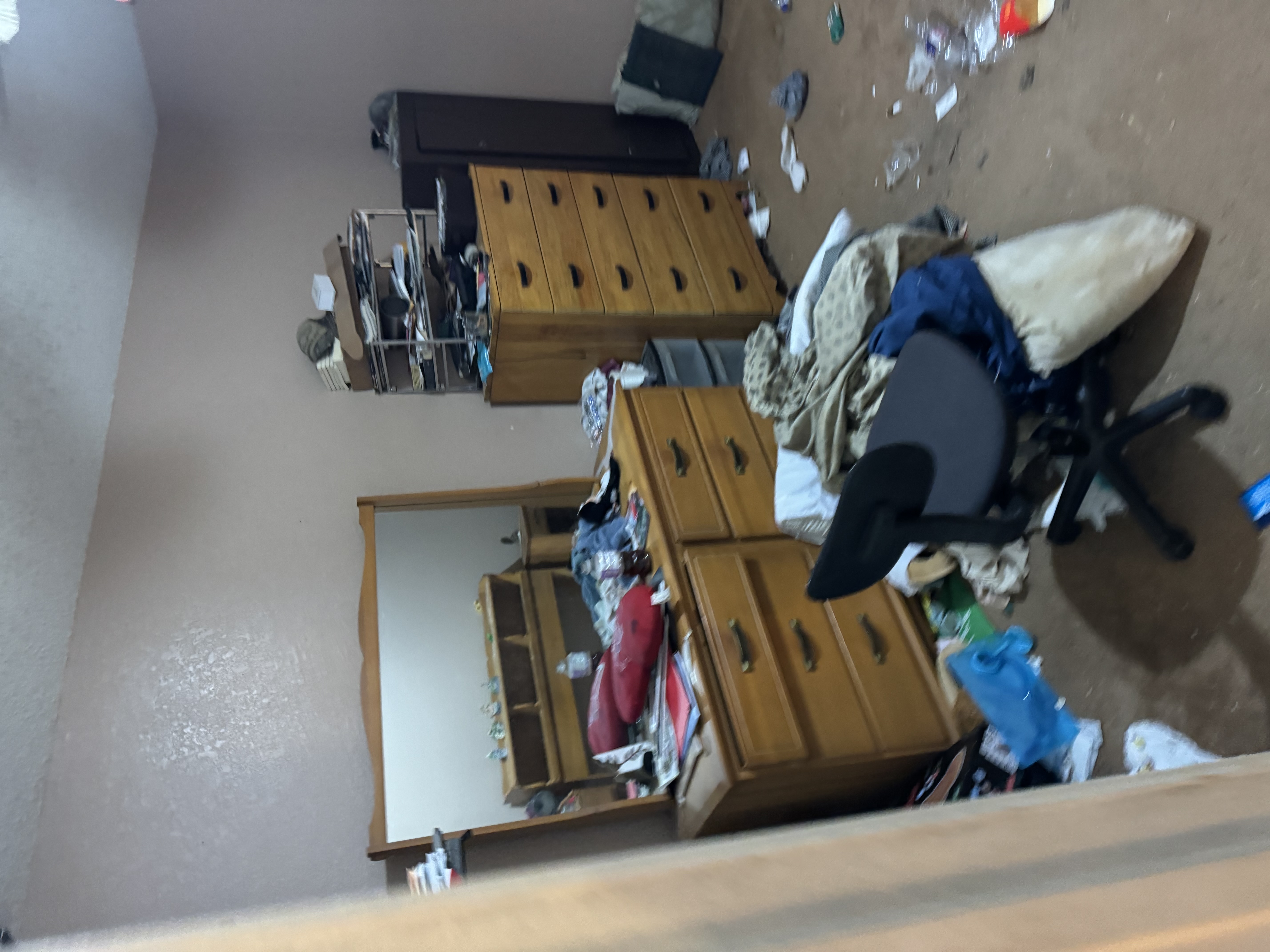 Cluttered room before rental cleanup and trash removal